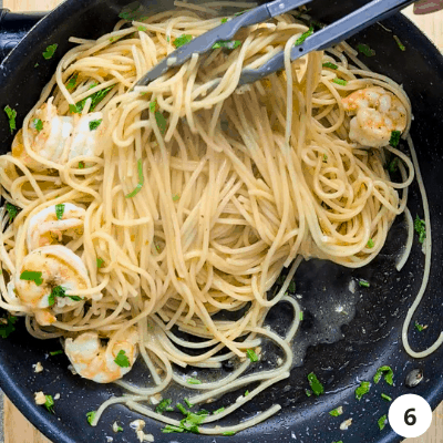 Mix well and serve garlic prawn pasta with a wedge of lemon