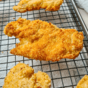Crispy, golden panko chicken schnitzel resting on a cooling rack