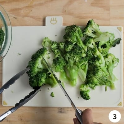 Cooked broccoli cut into small florets with a knife