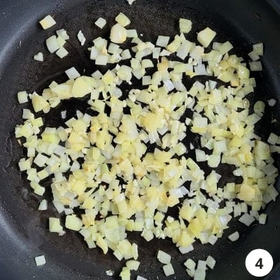 Finely diced ontions and minced garlic sauteing on a nonstick pan
