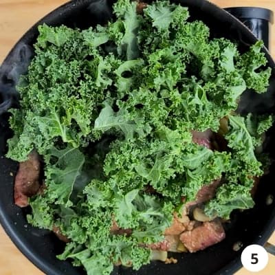 kale leaves added to pan