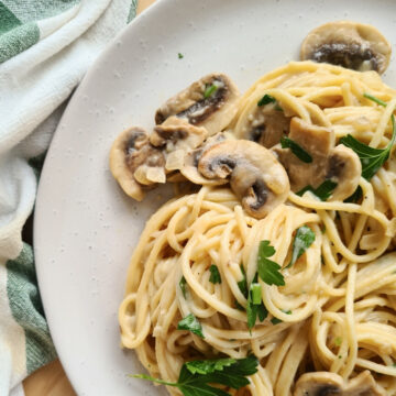 Close up of a plate of creamy mushroom pasta