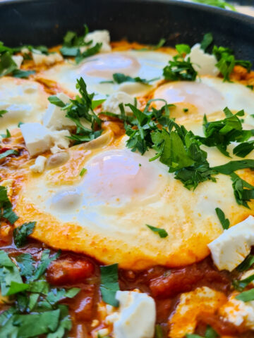 Close up of shakshuka with feta in a pan