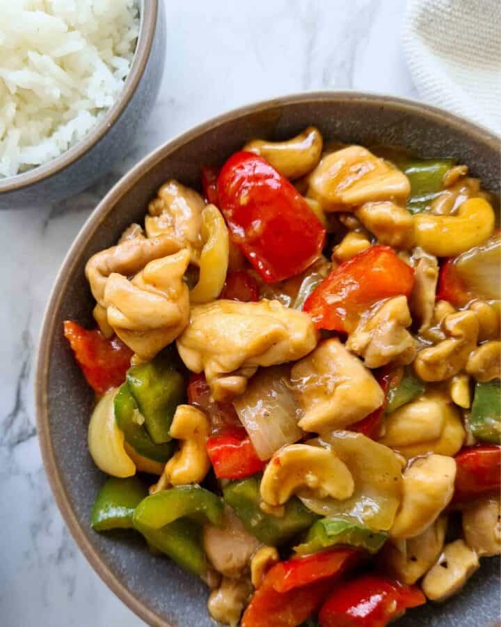 Close up of Chinese cashew chicken in a serving bowl. 