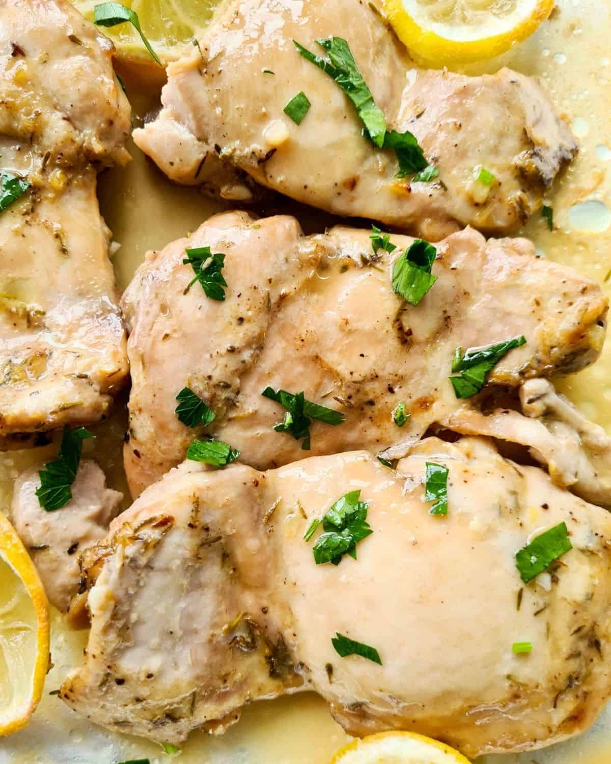Close up of juicy lemon chicken thighs straight out of the oven
