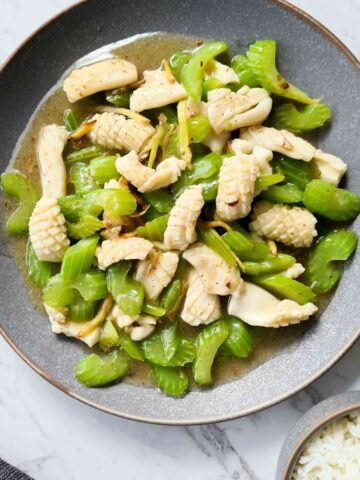 Squid and celery stir fry on a large grey plate