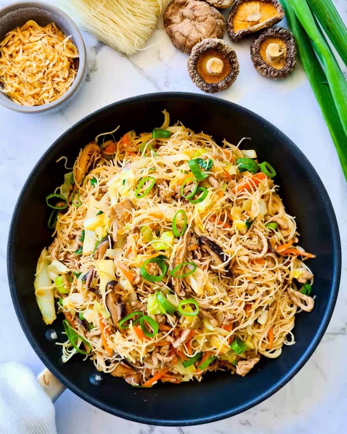 Freshly cooked vermicelli stir fry in a black pan