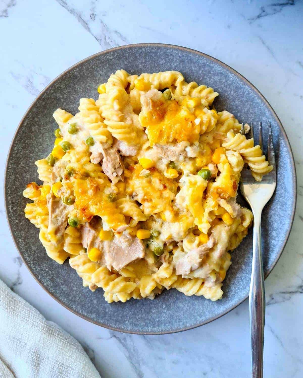 A plate of creamy tuna pasta bake with a fork