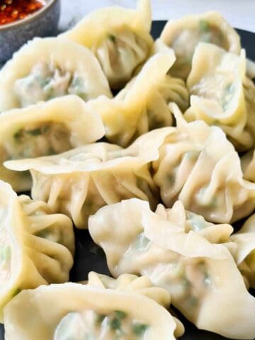 a plate of pork and chive dumplings