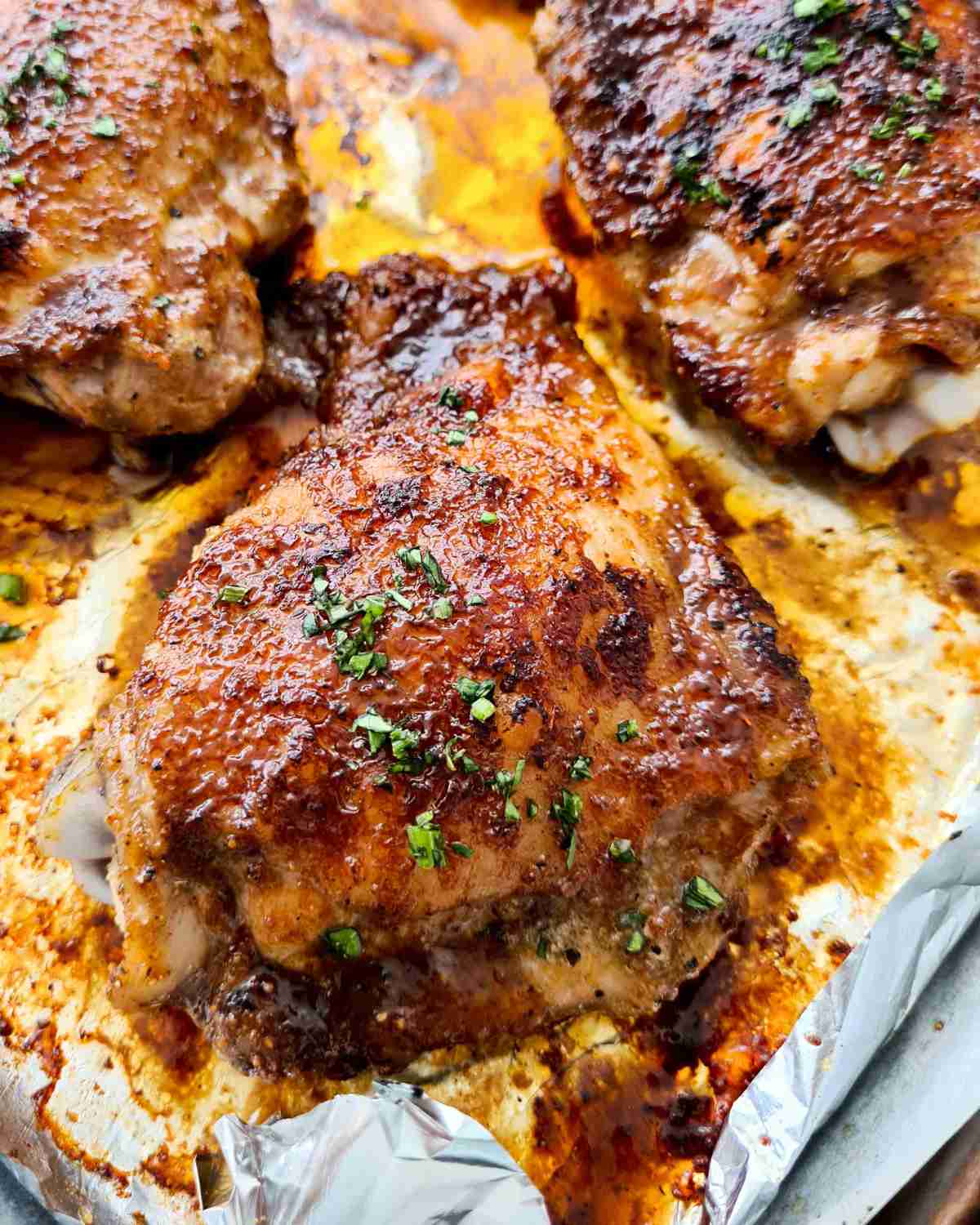 Close up of a glazed baked chicken thigh