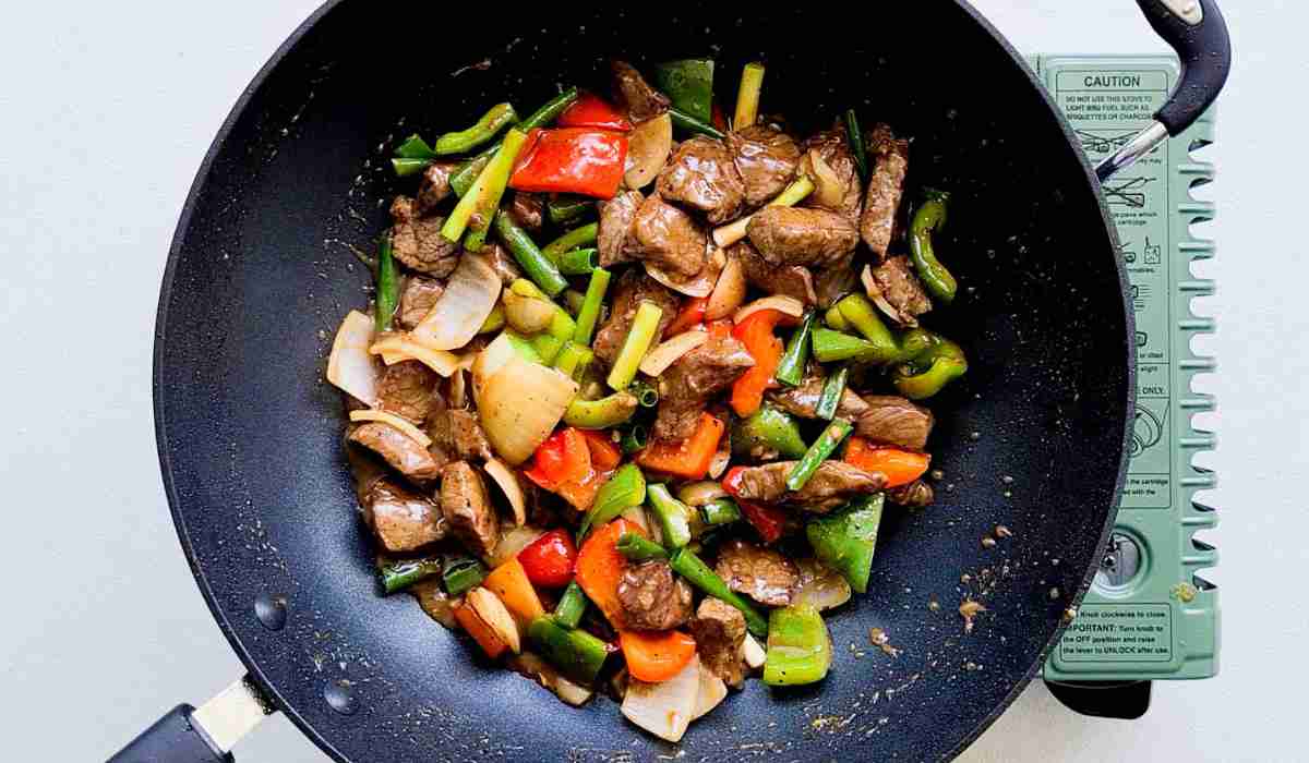 Close up of stir fried beef and vegetables in a wok