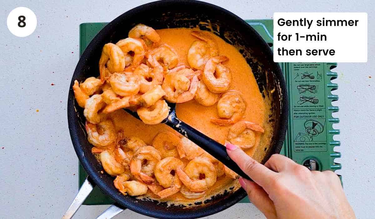 Shrimp (prawns) being simmered in a creamy garlicky sauce with caption