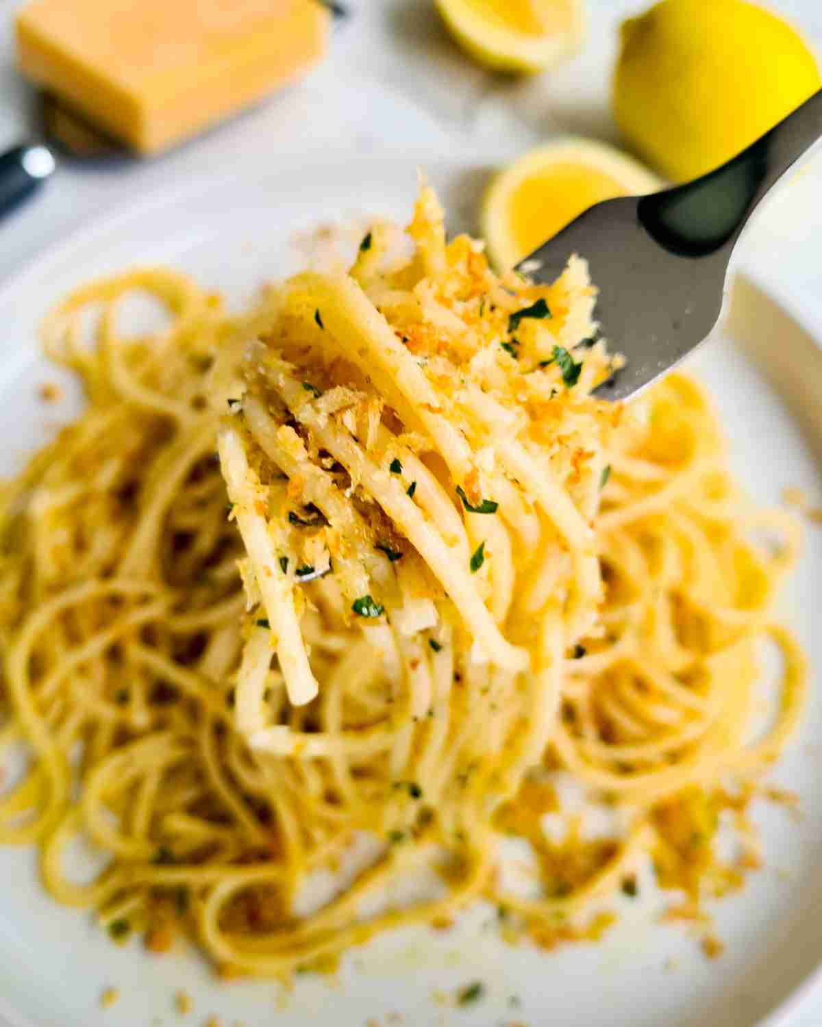 A forkful of lemon spaghetti over a plate