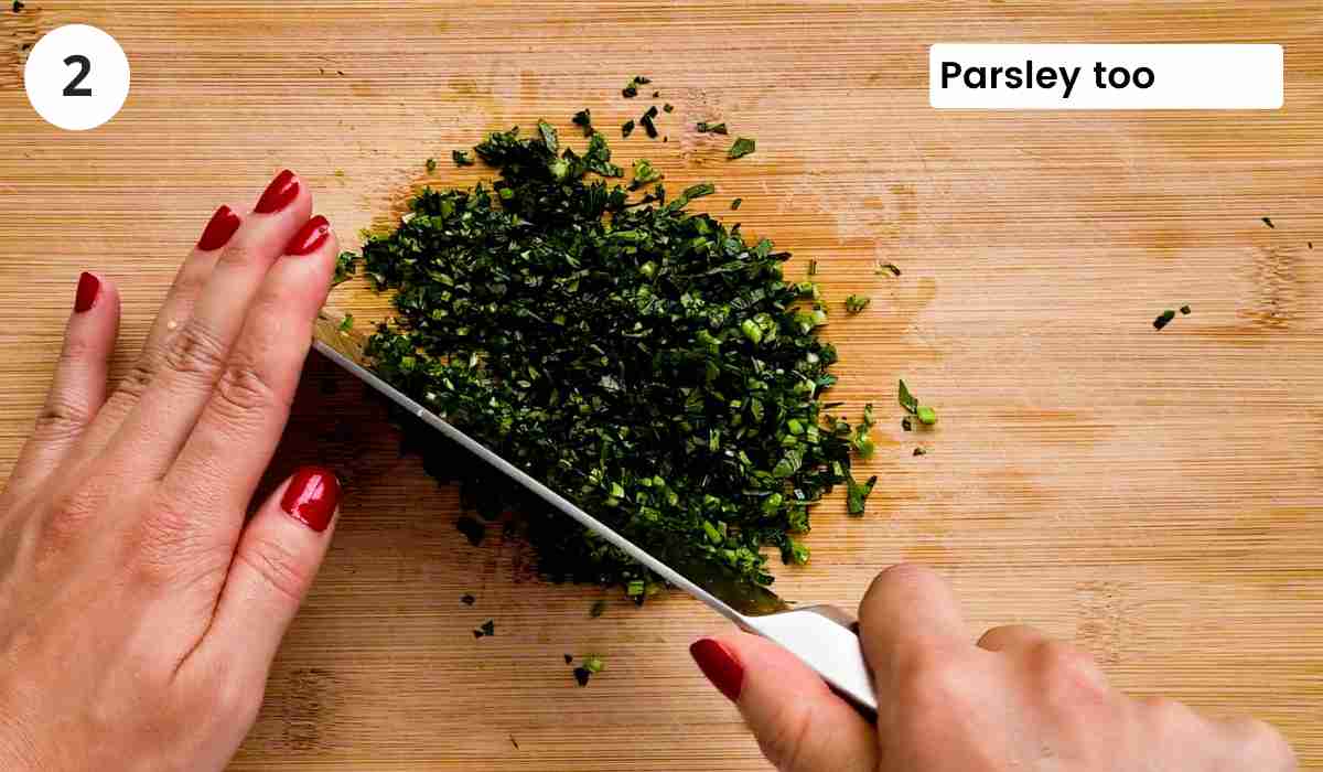 Fresh parsley being finely chopped with caption