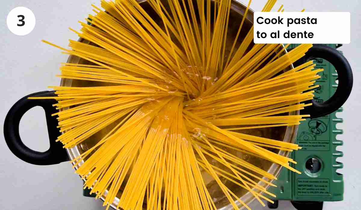 Spaghetti being cooked boiled with caption