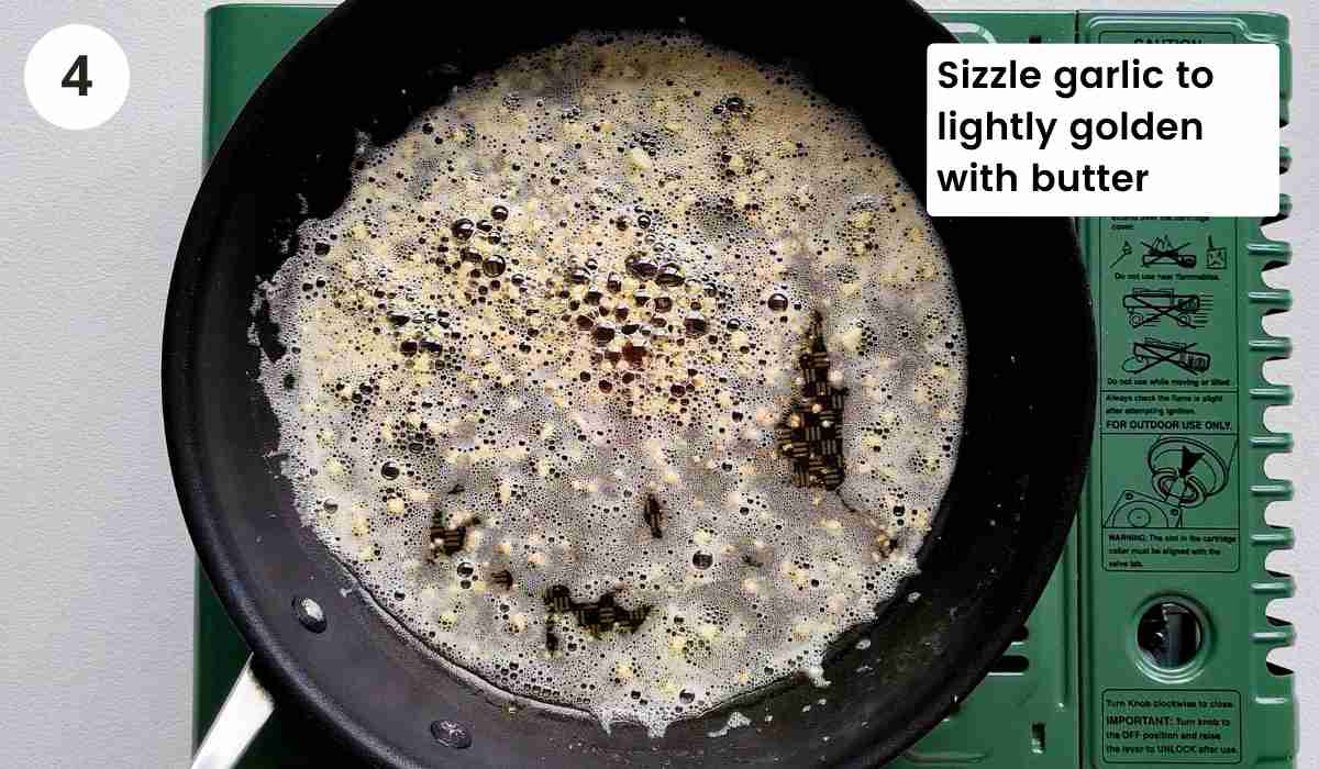 Minced garlic being fried in butter with caption
