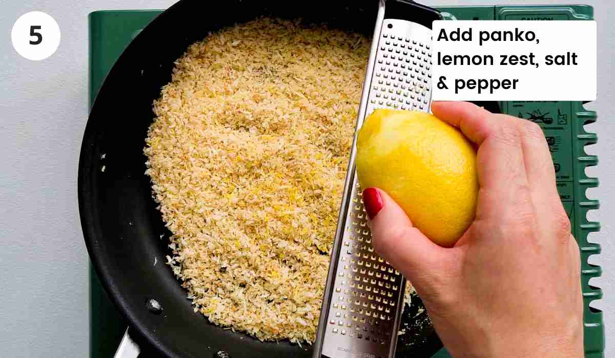 Breadcrumbs in frying pan with lemon being zested into the pan